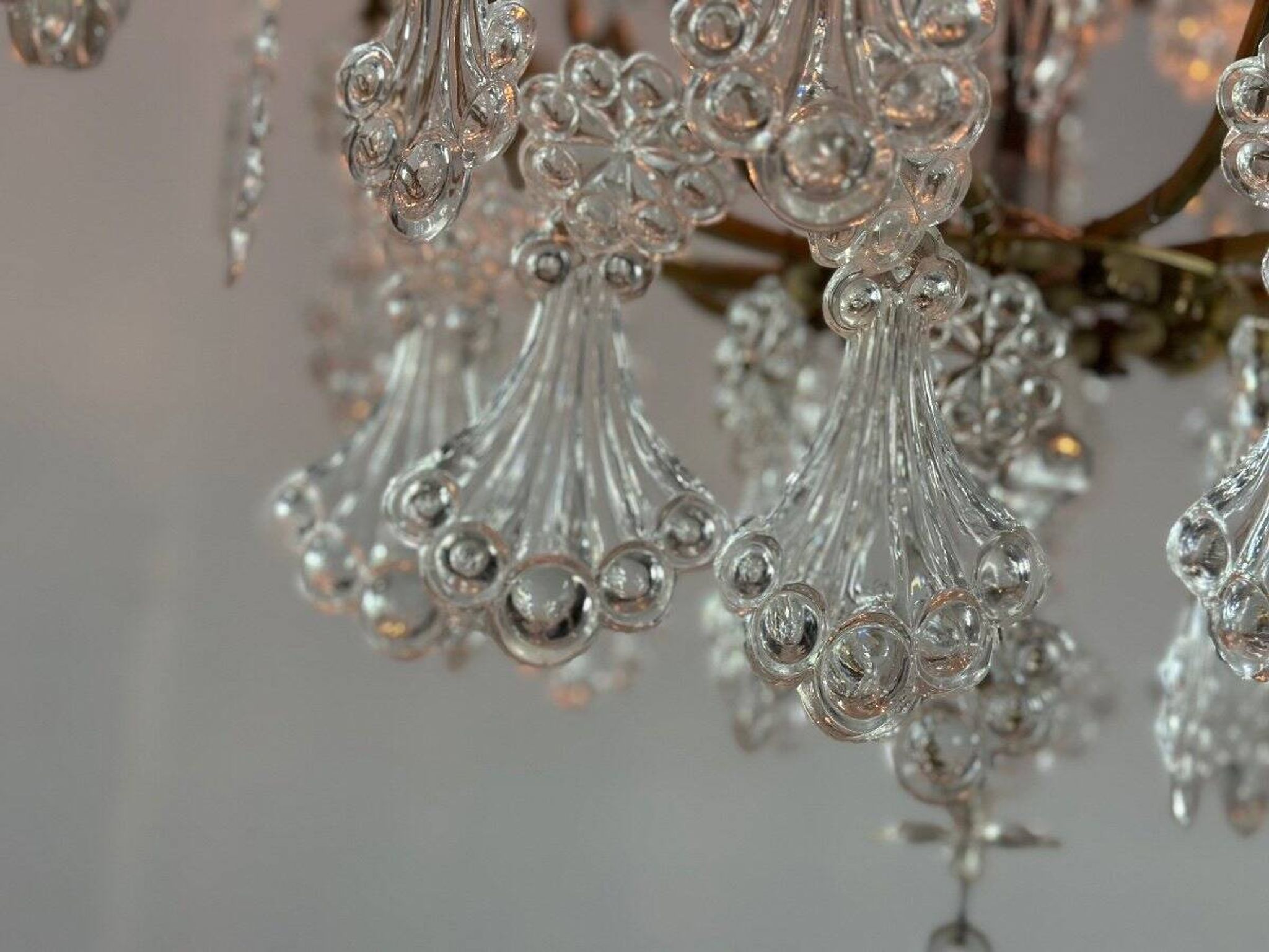 Bronze cage chandelier adorned with molded glass pendants in the shape of peacock feathers, circa 1800