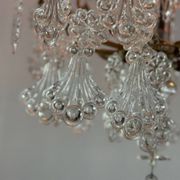 Bronze cage chandelier adorned with molded glass pendants in the shape of peacock feathers, circa 1800