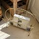 Vintage gold metal magazine rack from the 1960s.