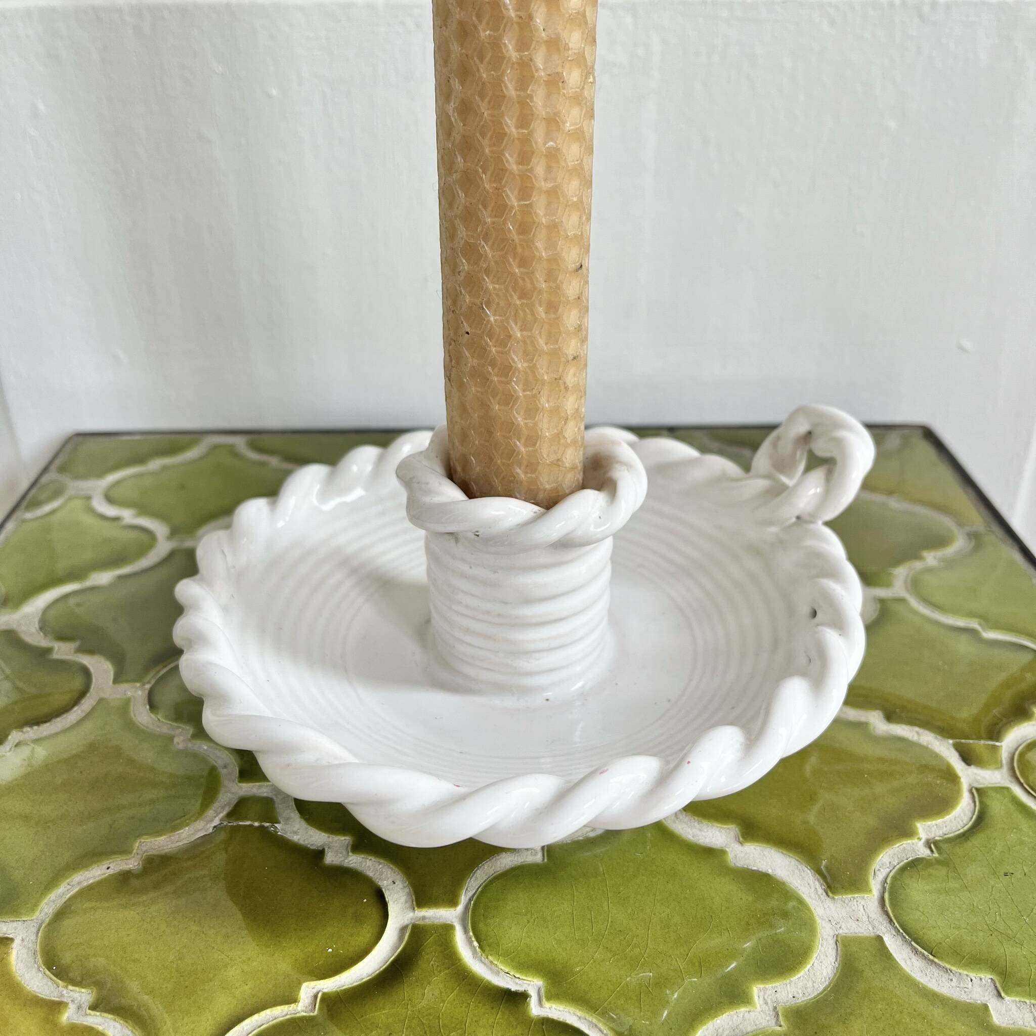 Hand-held candle holder with braided ceramic bowl