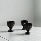 3 black ceramic egg cups with floral patterns