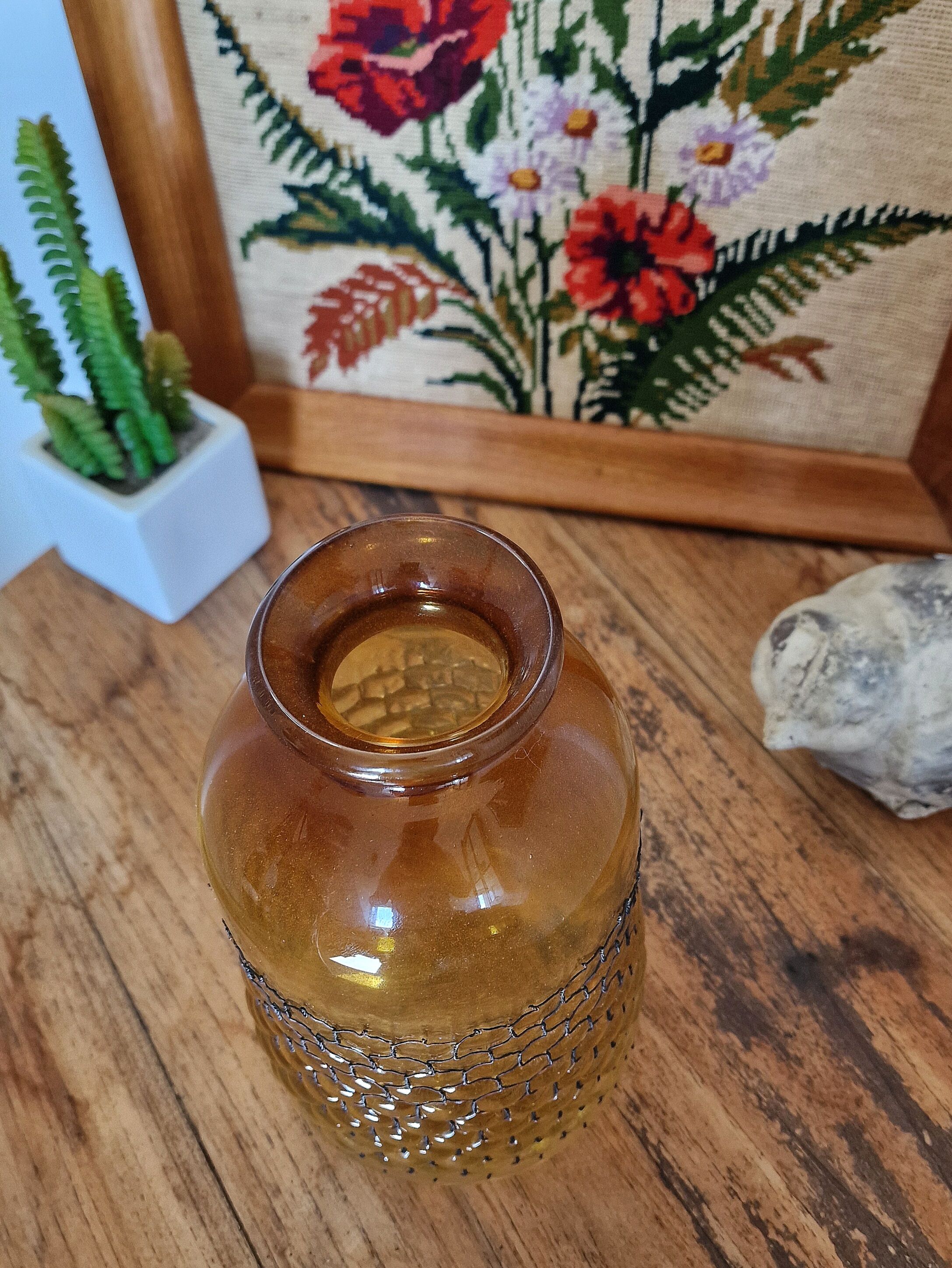 Artisanal blown amber glass vase with integrated honeycomb structure.