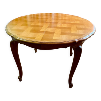 Round extendable wooden table with glass top