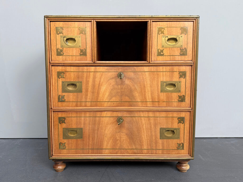 Antique campaign chest / ship’s chest, England, 1940s. Mahogany with a distinctive grain, brass inlays and hardware.