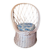 Vintage shell chair in woven rattan with original cushion.