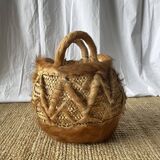 Handwoven vintage basket with handles made from natural fibres.