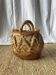 Handwoven vintage basket with handles made from natural fibres.
