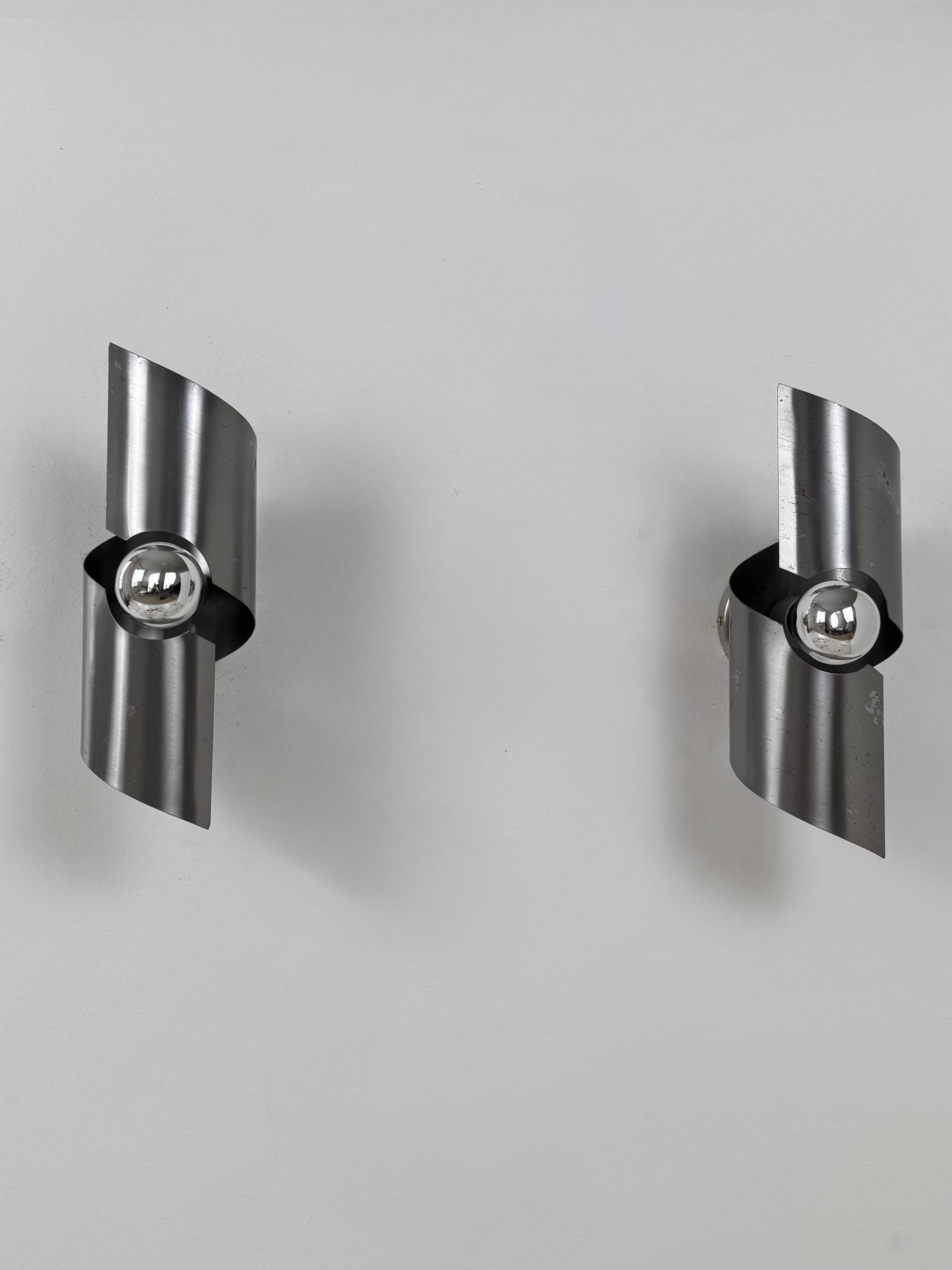 Pair of vintage wall lights, curved patinated steel, France, 1970.