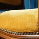 Velvet cabriolet armchair with decorative copper studs.