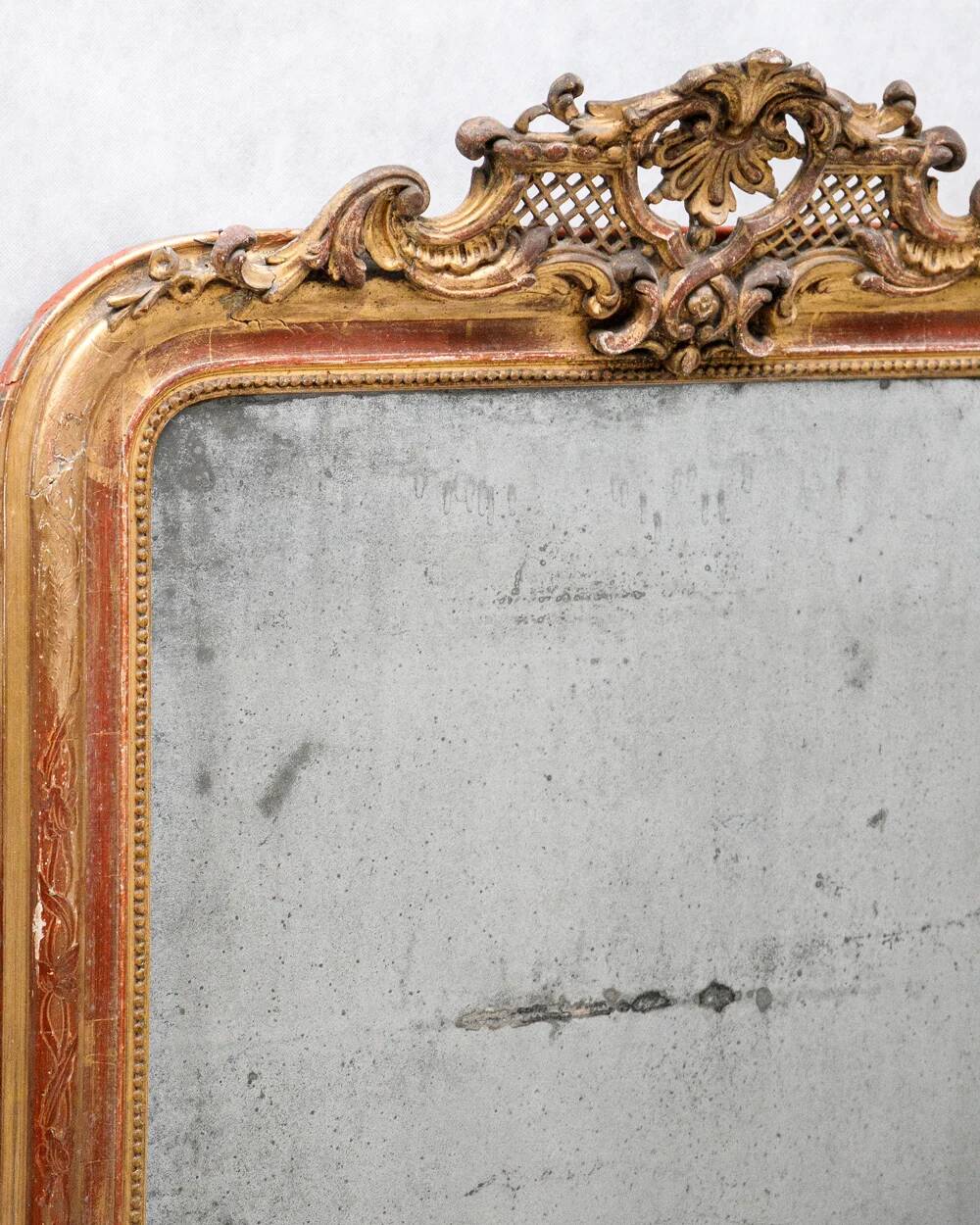 19th-century Louis-Philippe mirror with patina and pediment.