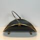 Neoclassical log holder in brass and black lacquered brass