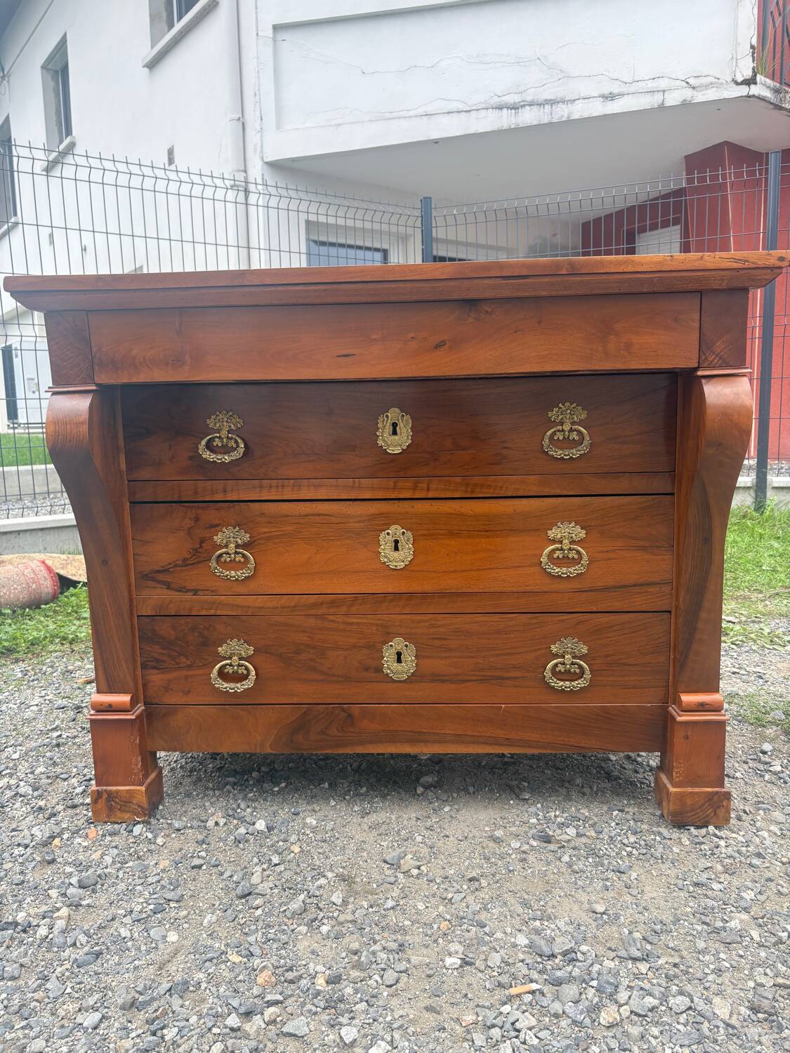 Restoration period walnut chest of drawers with a scroll handle