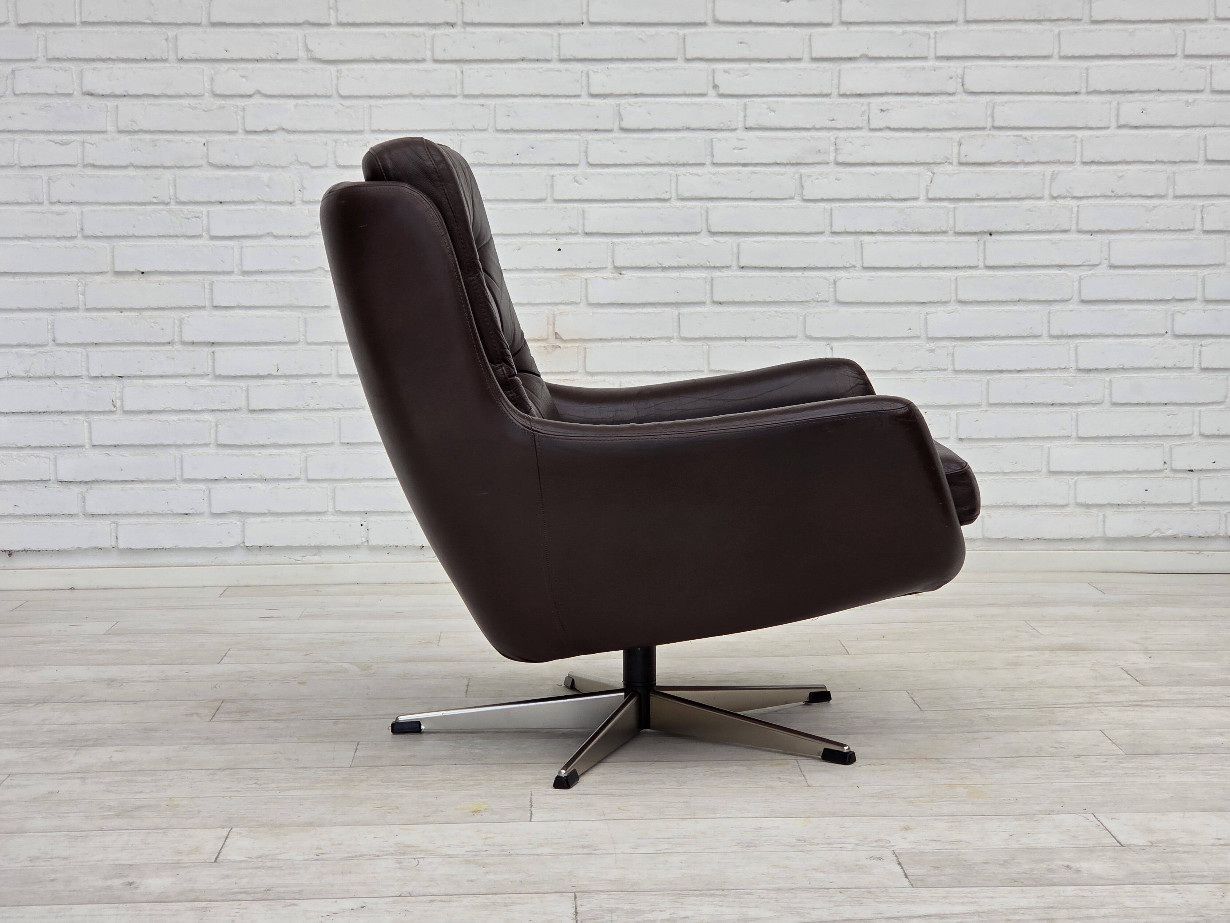 1970s, set of two swivel lounge chairs with footstool, leather.