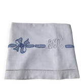 Embroidered single bedspread YM with blue knotted ribbon.