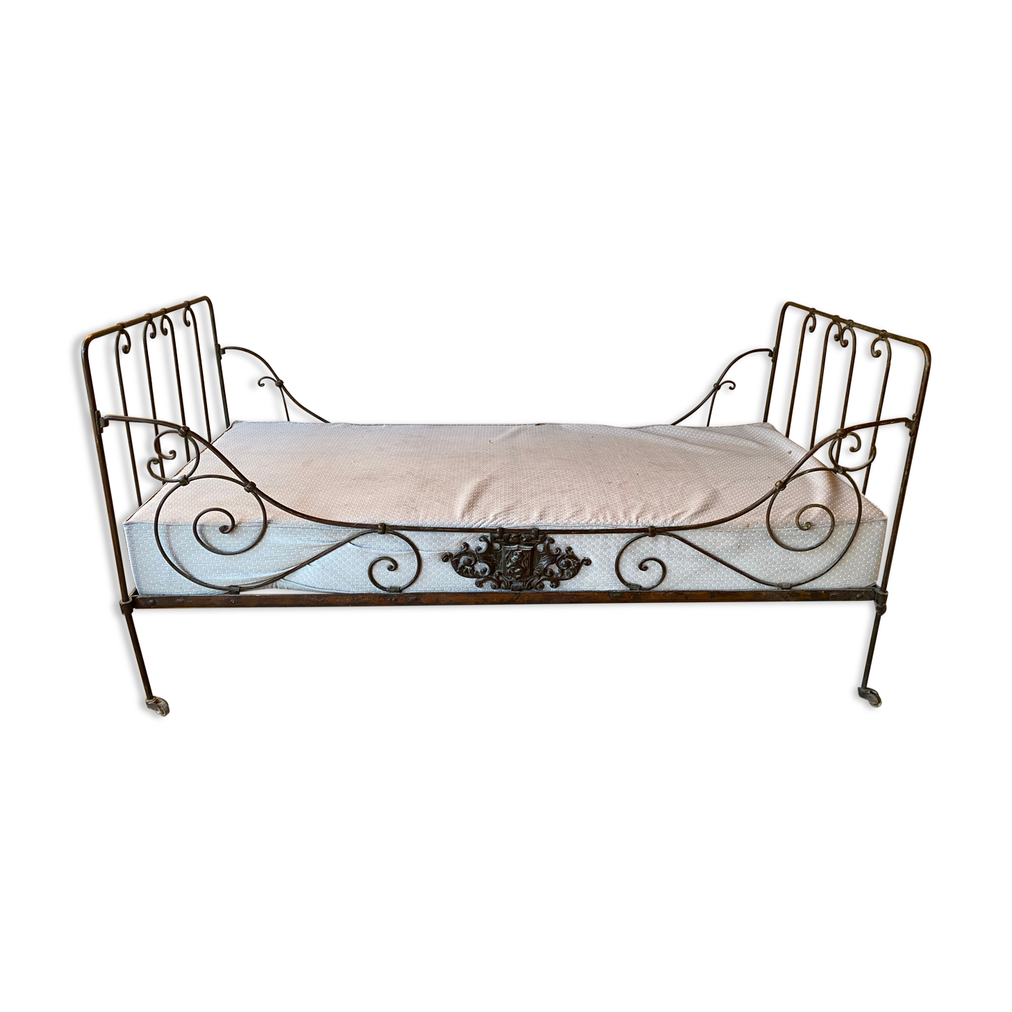 Wrought iron bed with mattress and decorative cover