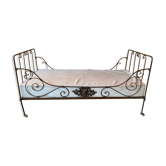 Wrought iron bed with mattress and decorative cover