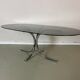 Vintage coffee table from the 70s in smoked glass and chrome, oval, Space Age style.