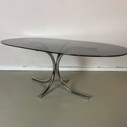 Vintage coffee table from the 70s in smoked glass and chrome, oval, Space Age style.