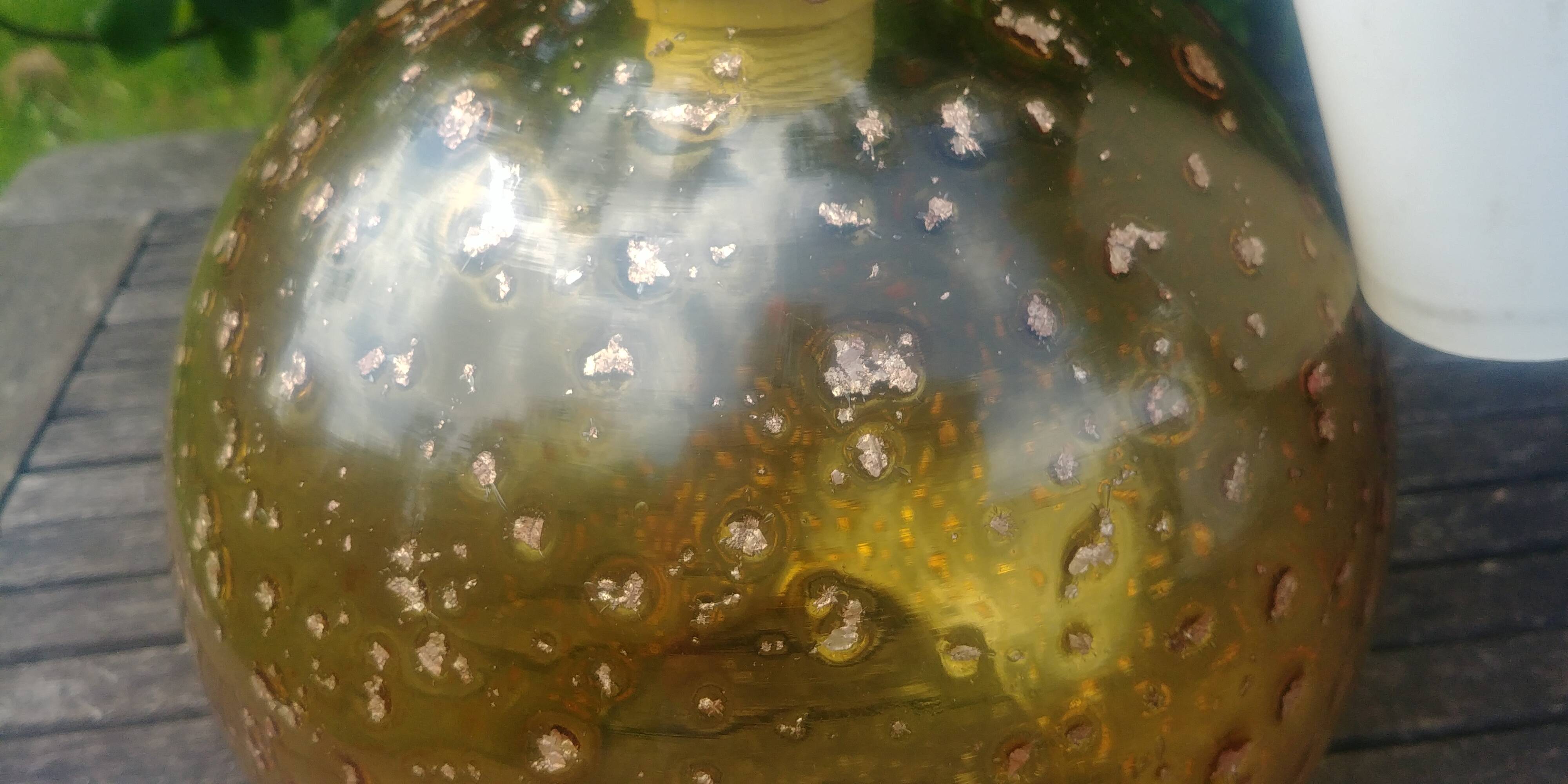 A vintage 70s blown glass pendant light with gold glitter in a globe shape