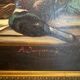 Still life with bottle and game, signed, 20th century