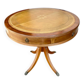 Round mahogany table with leather top in English style.