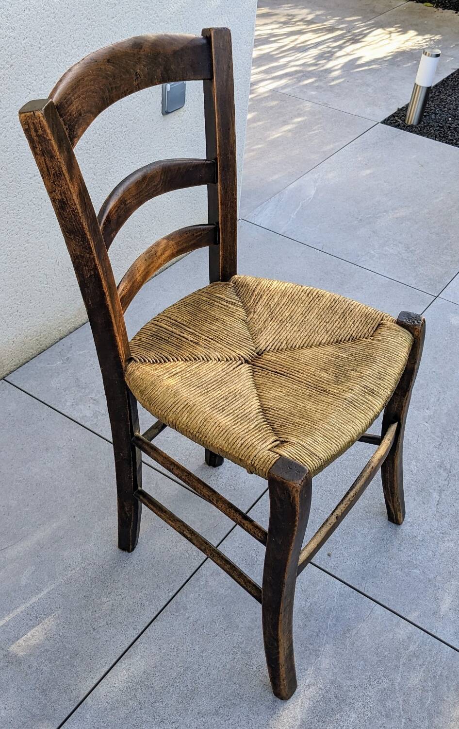 4 mismatched wood and straw chairs