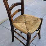 4 mismatched wood and straw chairs