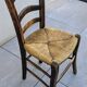 4 mismatched wood and straw chairs