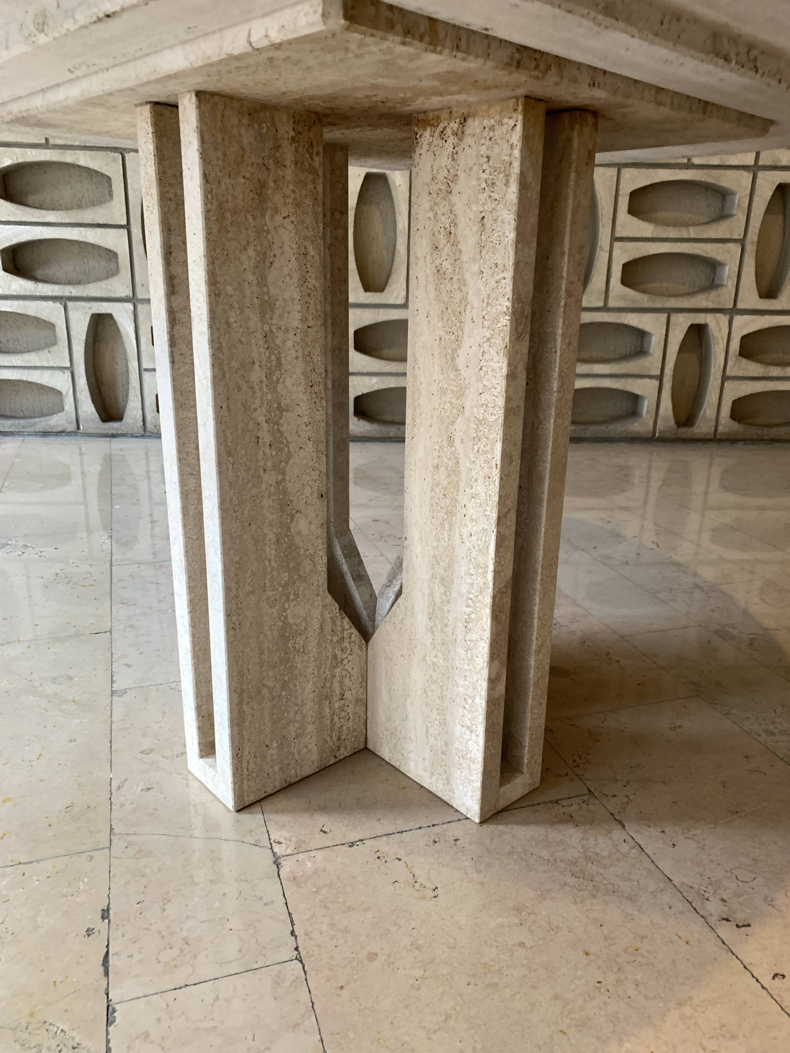 Round travertine dining table by Claude Berraldacci