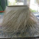 Wall lamp in natural fibres, woven straw with fringes.