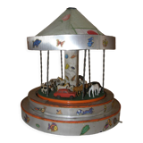 Old toy made of wood, aluminum and fabrics, animated and musical merry-go-round