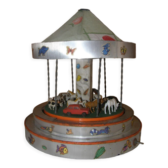 Old toy made of wood, aluminum and fabrics, animated and musical merry-go-round
