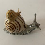 Porcelain figurine snail and its small
