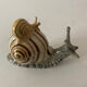Porcelain figurine snail and its small