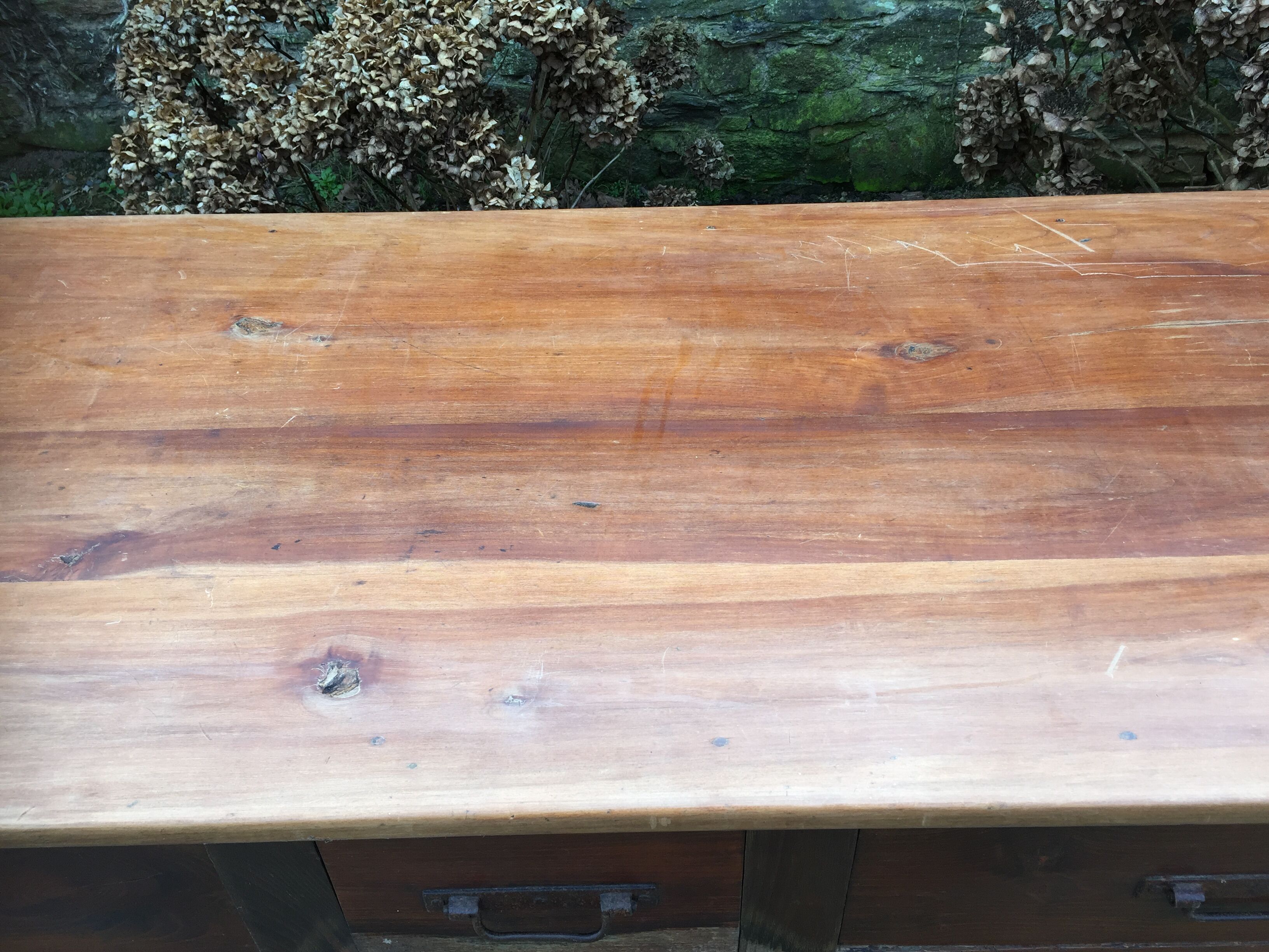 Old farmhouse table with cherry and chestnut panels with 3 drawers.