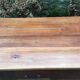 Old farmhouse table with cherry and chestnut panels with 3 drawers.