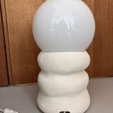 Large table lamp in off-white ceramic with an organic globe shape.