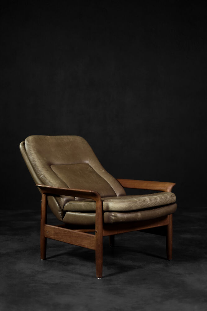 High teak and brown leather armchair with reclining backrest, mid-century Danish style, 1960s.