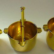 Three "vintage" bronze ashtrays with golden natural patina forming mortars with their drumsticks