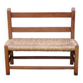 Wooden-backed bench with straw seat, 1970s.