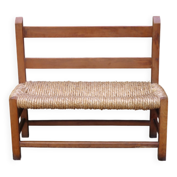 Wooden-backed bench with straw seat, 1970s.