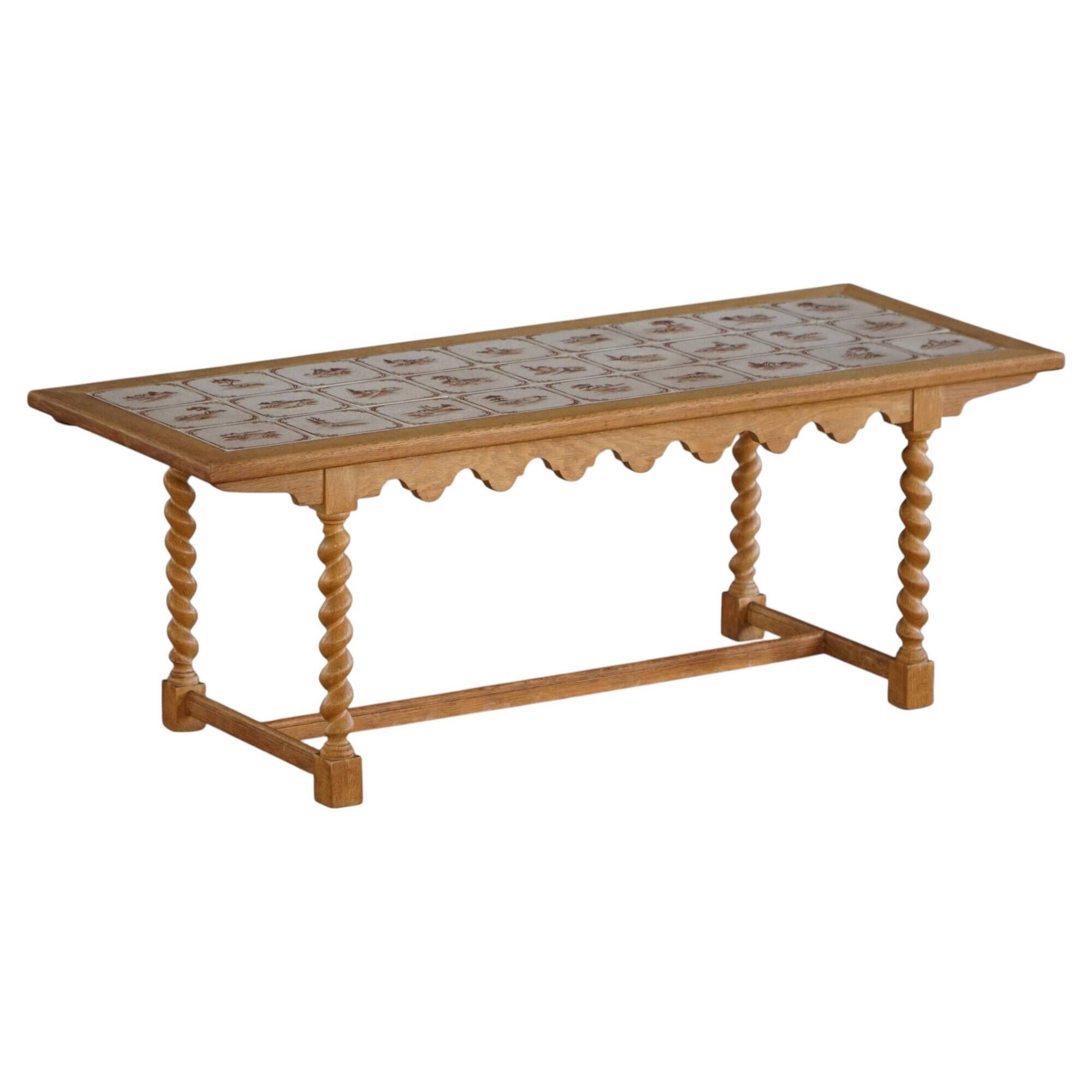 Mid-century modern Danish coffee table in oak with a ceramic top, 1950s.