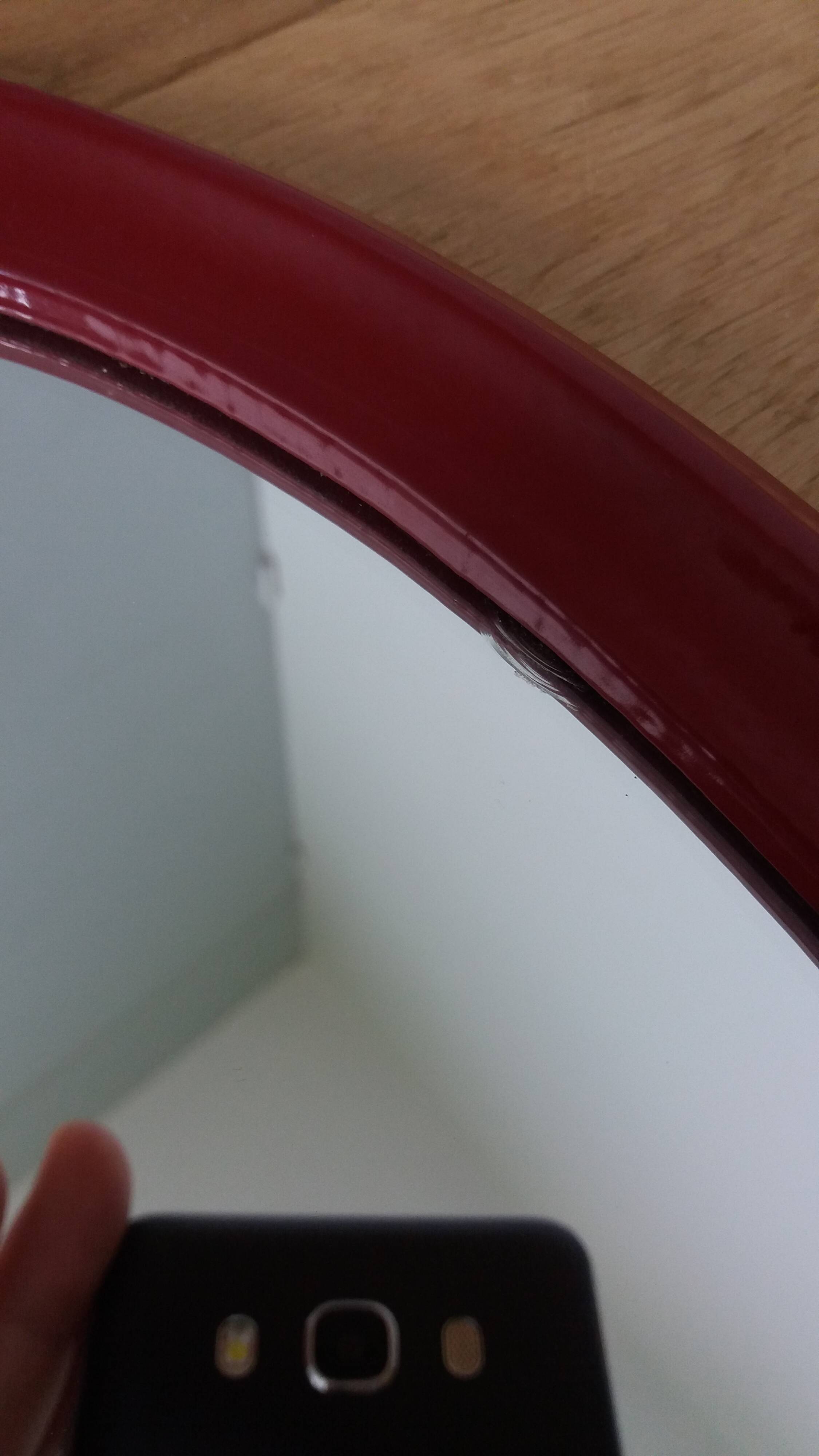 Oval mirror, red enamelled metal in Art Deco style, 49 x 39 cm.