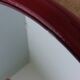 Oval mirror, red enamelled metal in Art Deco style, 49 x 39 cm.