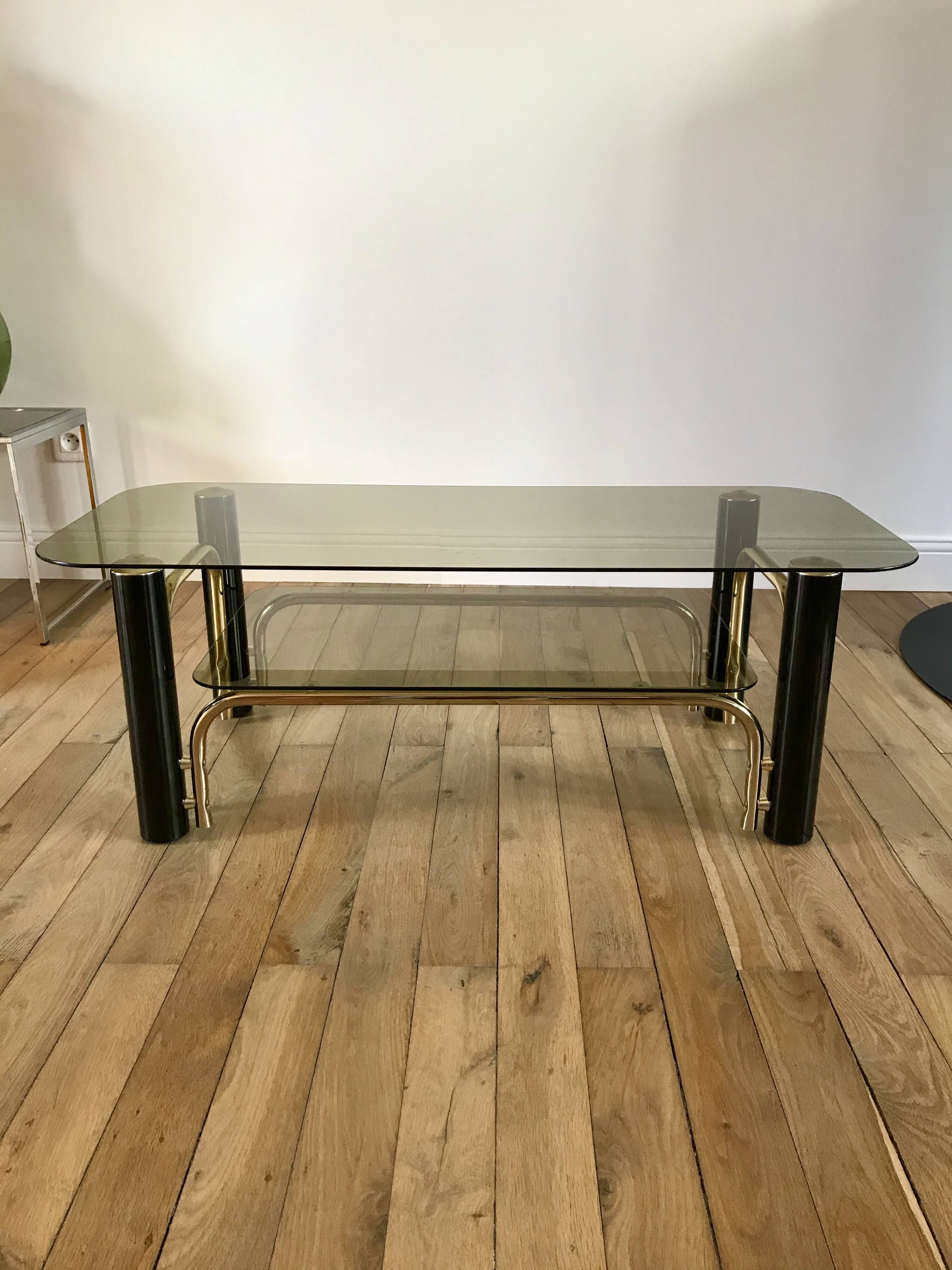 coffee table in smoked glass and black and gold metal from the 70s