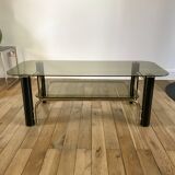 coffee table in smoked glass and black and gold metal from the 70s