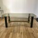 coffee table in smoked glass and black and gold metal from the 70s