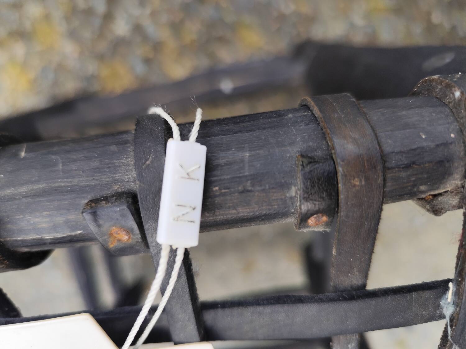 5 blackened wooden stools with woven leather seats by Nina Kaufmann