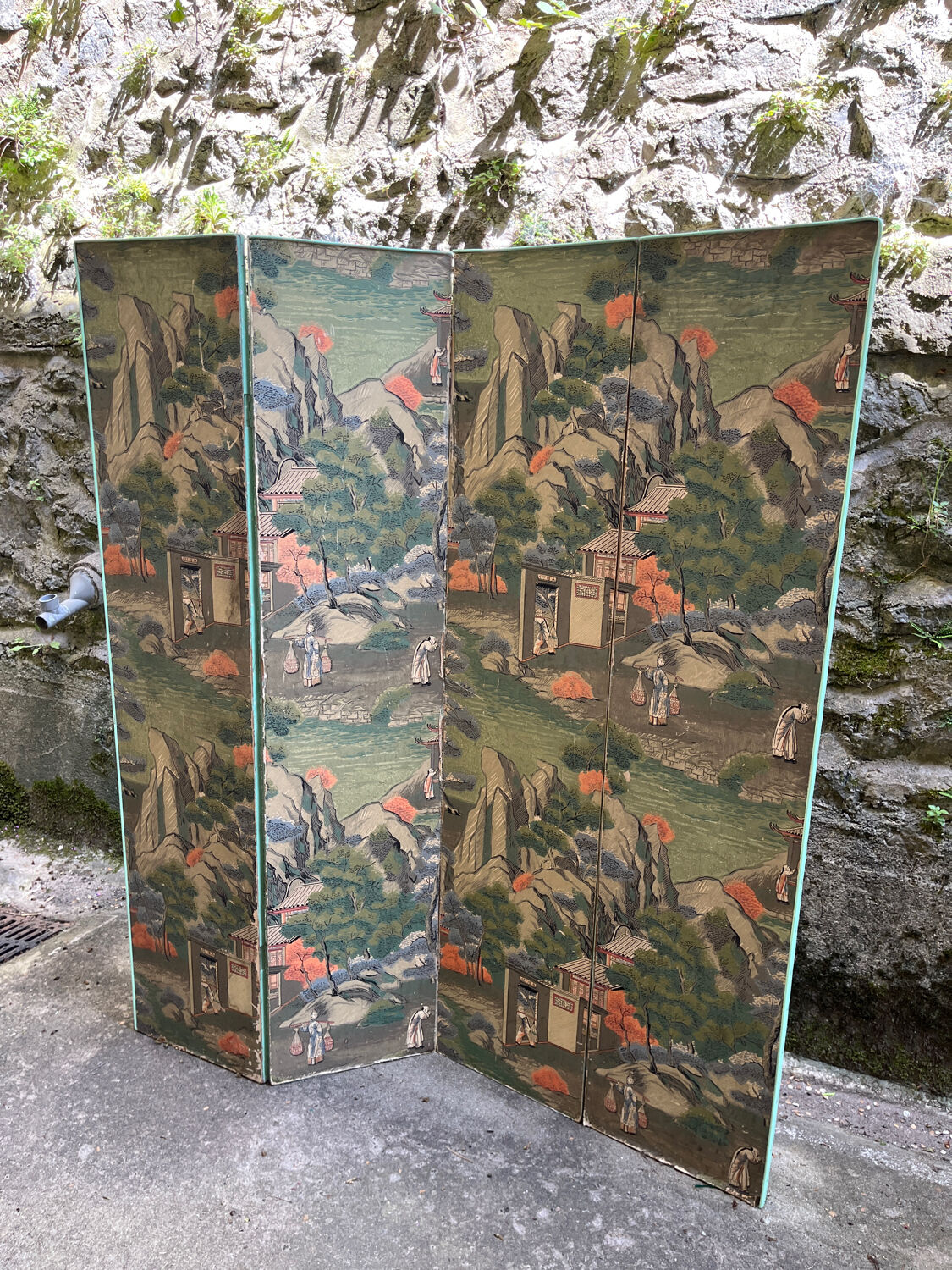Wooden screen in Asian style, covered with Chinese wallpaper.