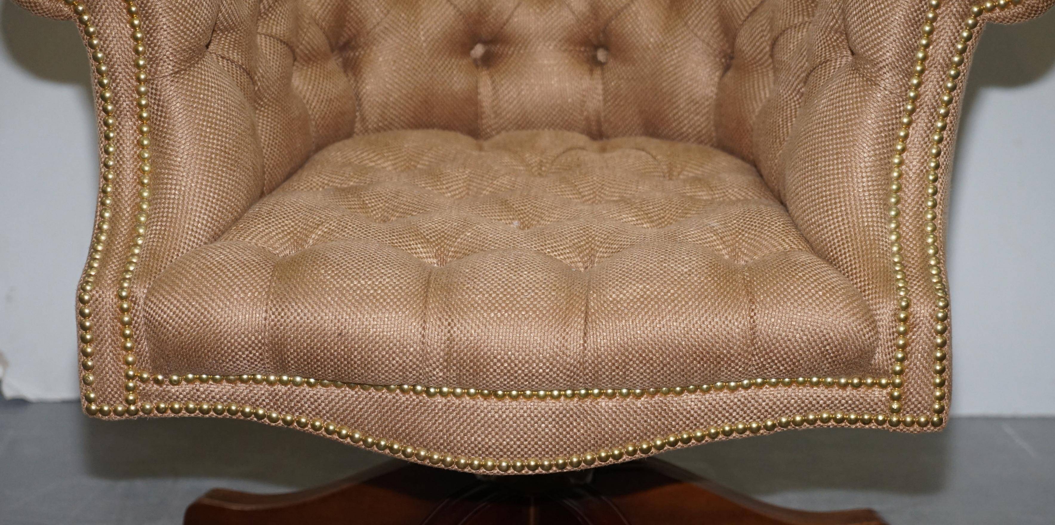 Chesterfield armchair in hardwood, leather, and woven linen.